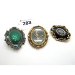 A Victorian Black Enamel and Seed Pearl Set Mourning Brooch, with glazed hairwork panel; a Victorian