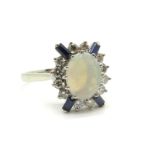 An 18ct White Gold Opal and Diamond Set Cluster Ring, oval claw set to the centre with a (9x7mm)