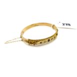 A 9ct Gold Bangle, alternately set to the front, hinged to snap clasp, Chester 1904.