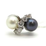 A Pearl and Diamond Set Dress Ring, of crossover design set with one white and one grey pearl,