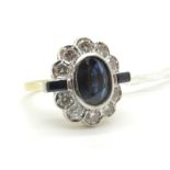 A Large 18ct Gold Sapphire and Diamond Cluster Ring, oval collet rubover set to the centre with a (