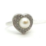 A Modern Pearl and Diamond Set Dress Ring, single pearl set to the centre within heart shape border,