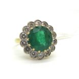 A Large 18ct Gold Emerald and Diamond Cluster Ring, claw set to the centre with a (11mm) circular