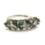 An 18ct White Gold Emerald and Diamond Cluster Ring, the three stone line of alternating uniform