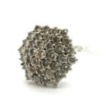 An 18ct White Gold Diamond Set Cluster Ring, the uniform brilliant cut stones in hexagonal design