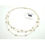 A Modern 18ct Gold and Pearl Three Row Necklace, to twist clasp.