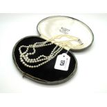 A Three Row Graduated Pearl Bead Necklace, knotted to single cut diamond set clasp stamped "750". *