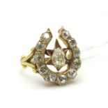 A Victorian Diamond Set Horseshoe Ring, claw set to the centre with a (6x4mm) pear shape diamond,