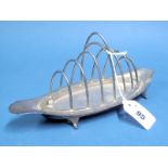 A Hallmarked Silver Seven Bar Toast Rack, HA, Sheffield 1910, of plain elongated oval form, on