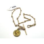 A 9ct Gold Fancy Link Albert Chain, suspending T-bar and religious pendant.