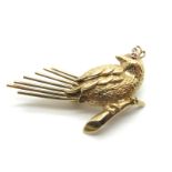 A 9ct Gold Stylised "HoHo" Bird Brooch, with inset ruby eye, detailed in relief with applied wings.