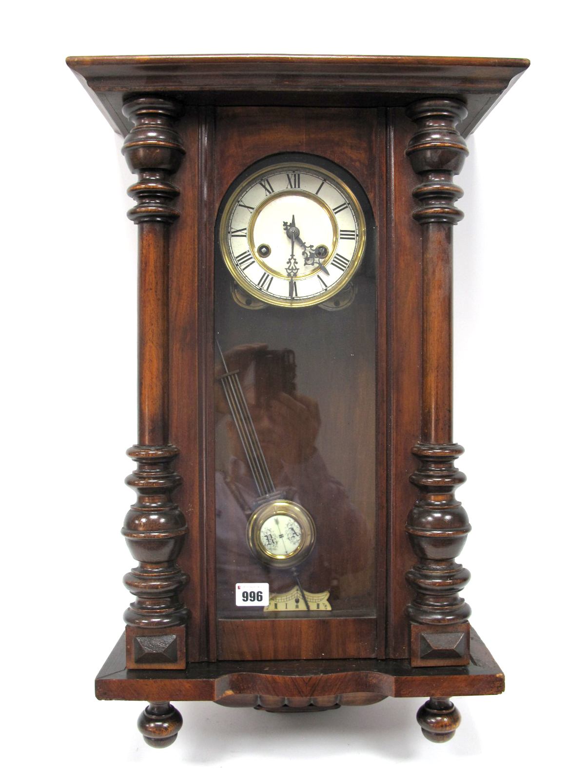 A Late XIX Century Vienna Wall Clock, the white enamel dial with Roman numerals, in a mahogany case,