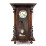 A Late XIX Century Vienna Wall Clock, the white enamel dial with Roman numerals, in a mahogany case,