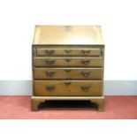 A George III Mahogany Bureau, with fall front and fitted interior over four graduated drawers on