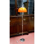 A 1970's Harvey Guzzini Floor Lamp, with adjustable tangerine plastic shade on a chrome stand and