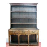 An XVIII Century Joined Oak Dresser, the upper with two shelves and panelled back, the base with