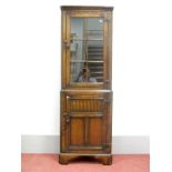 A Titchmarsh & Goodwin Style Oak Glazed Double Height Corner Cupboard, with dentil cornice, glazed
