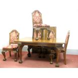 A XX Century Walnut Dining Suite, with draw leaf table, on carved cabriole legs with ball and claw