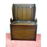 A Titchmarsh & Goodwin Style Oak Box Settle, with panelled back, shaped sides, hinged seat, 36cm