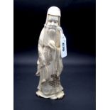 A Japanese Late XIX Century Ivory Figure, carved as a Sage holding a fruit, signed in a red seal,