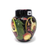 A Moorcroft Pottery Ginger Jar and Cover, painted in the 'Queens Choice' pattern against a dark blue