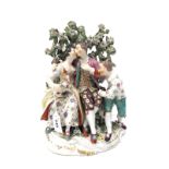 An XVIII Century Derby Porcelain Figure Group, modelled as a seated couple, holding a dog, another