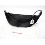 Salvatore Ferragamo; A black monogram print canvas shoulder purse, with slim black leather handle,