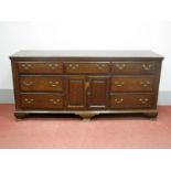 A Late XVIII Century Oak Dresser Base, with marquetry crossbanded top, central drawer over twin