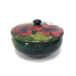 A Moorcroft Pottery Powder Bowl and Cover, of circular form, painted in the 'Hibiscus' pattern
