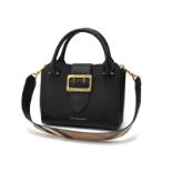 Burberry: A Soft Grain Small Buckle Tote, in black, model number 4033797, with gold tone hardware,