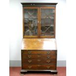 A George III Mahogany Bureau Bookcase, the top with dentil cornice over glazed astragal doors and