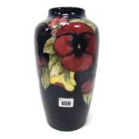 A Moorcroft Pottery Vase, of baluster form, painted in the 'Pansy' pattern against a dark blue