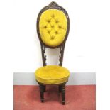 A XIX Century Oak Correction Chair, with arched top, carved acanthus decoration, upholstered back
