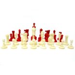 An Early/Mid XX Century Ivorine Chess Set, with white and red stained pieces. (32)