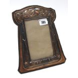 An Art Nouveau Copper Photograph Frame, of rectangular form, embossed with a galleon at sea and