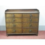 A XIX Century Mahogany Chest, with three-quarter galleried top over five drawers and cupboard, on