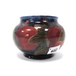 A Moorcroft Pottery Vase, of compressed globular form, painted in the 'Pomegranate' pattern