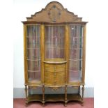 An Early XX Century Walnut Display Cabinet, with arched and shaped back, twin glazed bow fronted