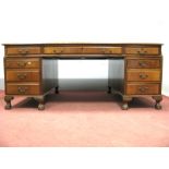 A Mahogany Partners Desk, circa early to mid XIX Century, with three scriver panels to moulded