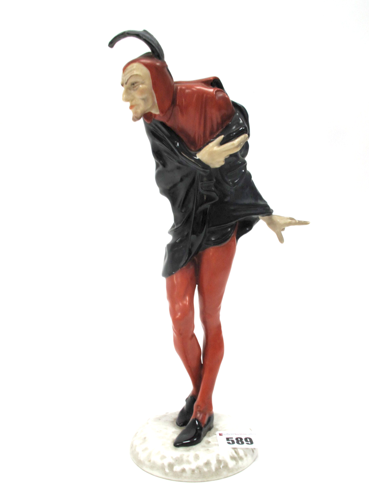 A Hutschenreuther Porcelain Figure of "Mephistopheles", wearing a red and black costume and a