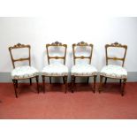 A Set of Four XIX Century Walnut Salon Chairs, with carved and scrollwork top rails, upholstered