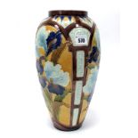 A Burmantoft Faience Partie-Colour Vase, of baluster form, moulded and painted with stylised iris