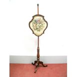 A XIX Century Mahogany Pole Screen, with woolwork tapestry panel of flowers, in a shaped frame,