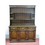 A Titchmarsh & Goodwin Oak Dresser, the panelled back with two shelves, the base with three small