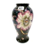 A Moorcroft Pottery Vase, of baluster form, painted in the 'Gustavia Augusta' pattern against a dark