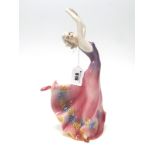 A Katzhutte Pottery Figure of a Dancing Lady, her arms held high and wearing a long pink/purple