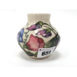 A Moorcroft Pottery Vase, of squat baluster form, painted in the 'Sweetness' pattern against a cream