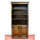 A Titchmarsh & Goodwin Style Oak Bookcase, with stepped cornice and three shelves over twin panelled