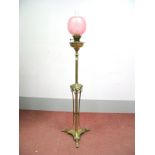 An Early XX Century Floor Standing Brass Oil Lamp, the central column with foliate swags and