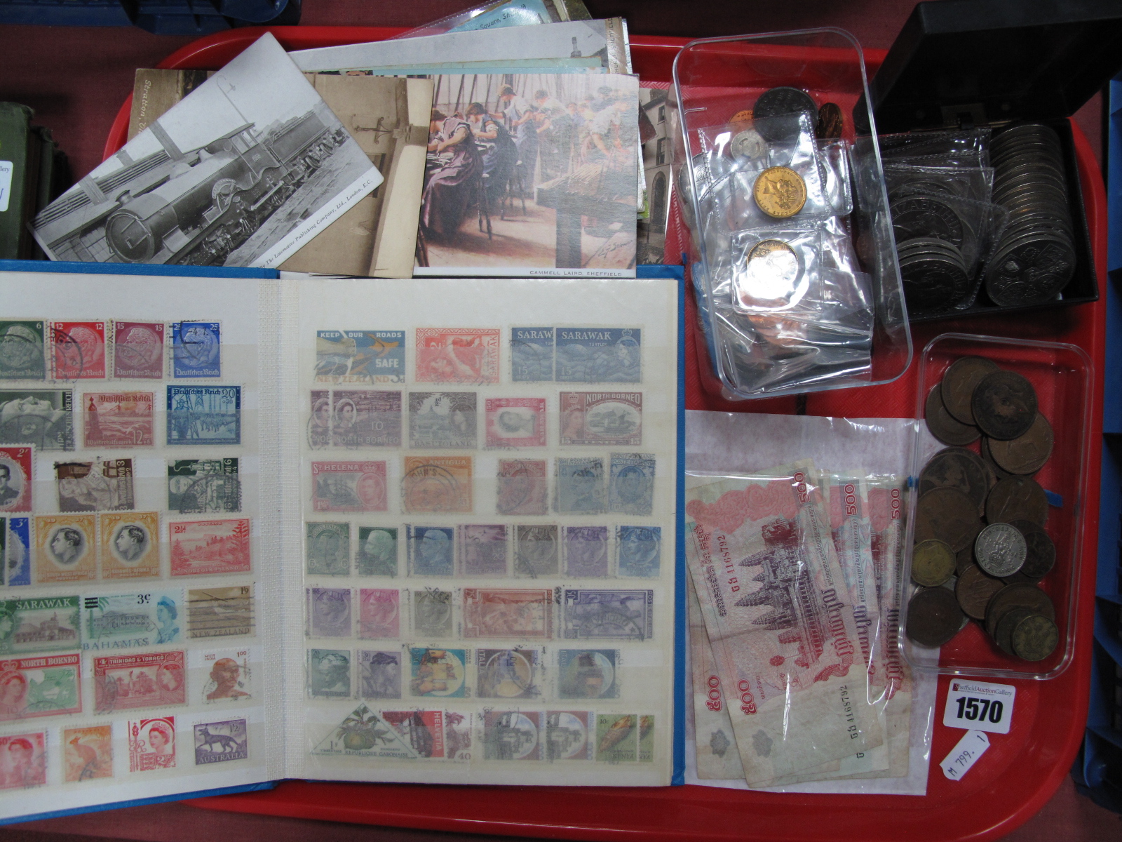 Postcards, S & G stamp album, quantity of coinage, Cambodian banknotes, etc:- One Tray